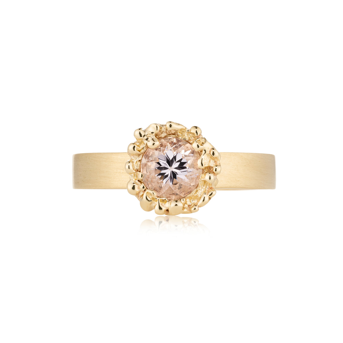 Gold ring with a diamond on a white background