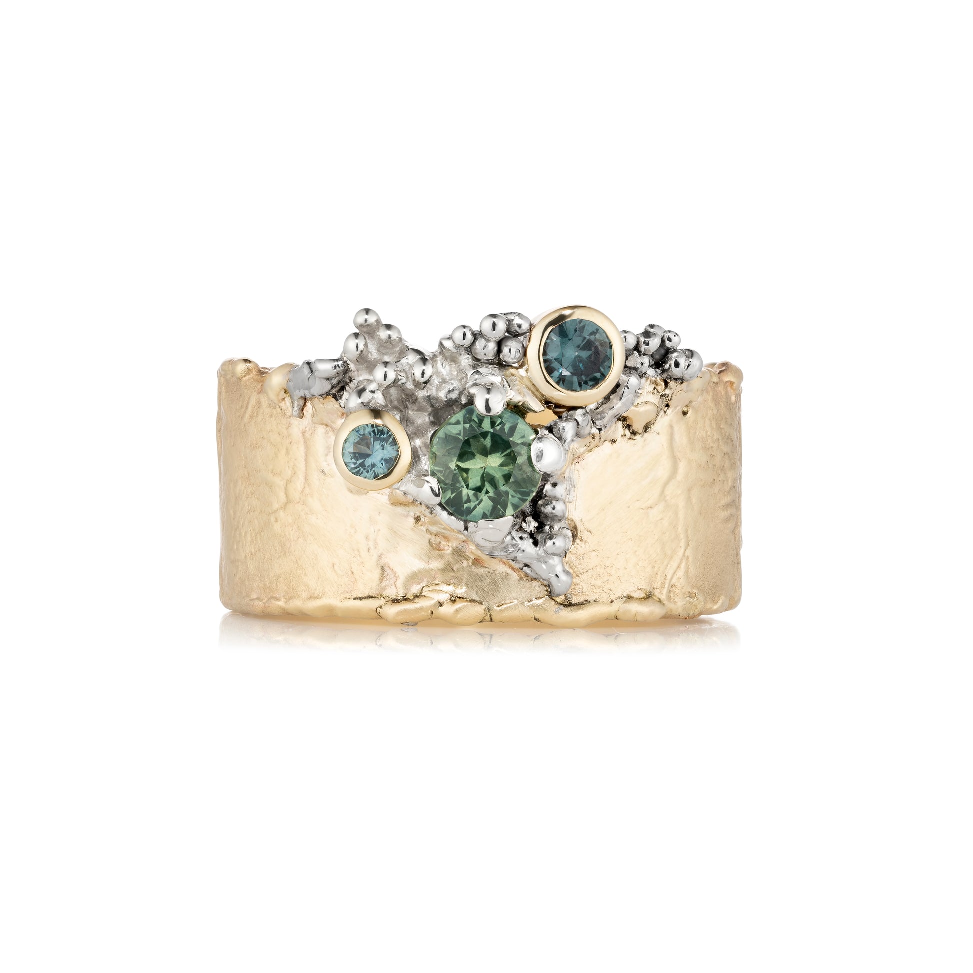 Gold ring with green sapphires on a white background