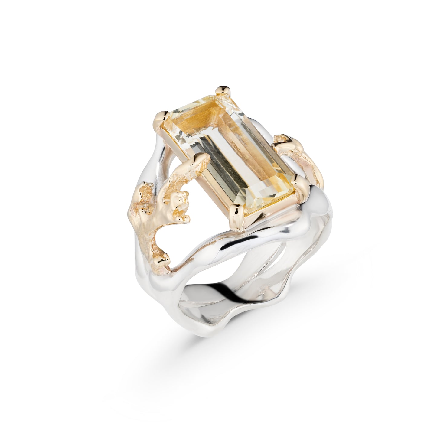 Gold and silver ring with a large rectangular gemstone on a white background