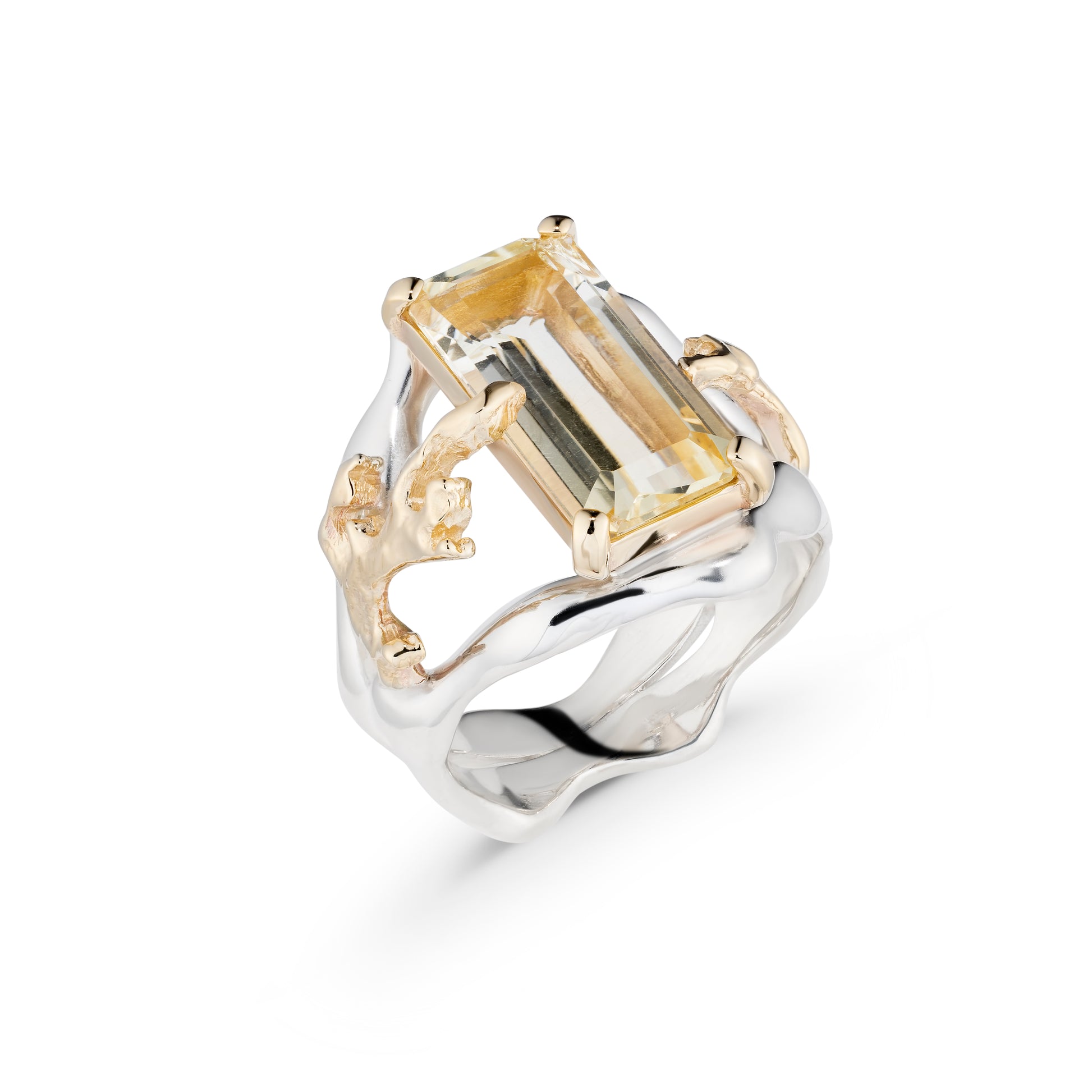 Gold and silver ring with a large rectangular gemstone on a white background
