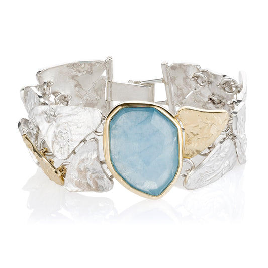 Silver and 9ct Yellow gold bracelet with a blue stone on a white background