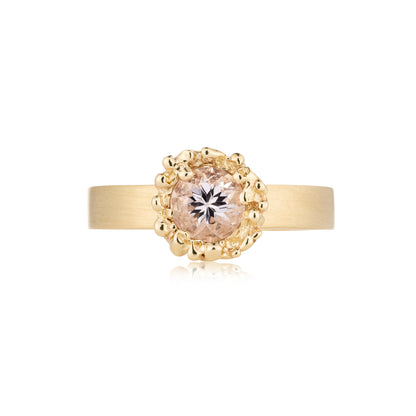 Gold ring with a diamond on a white background