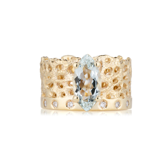 Gold ring with a central clear gemstone on a white background
