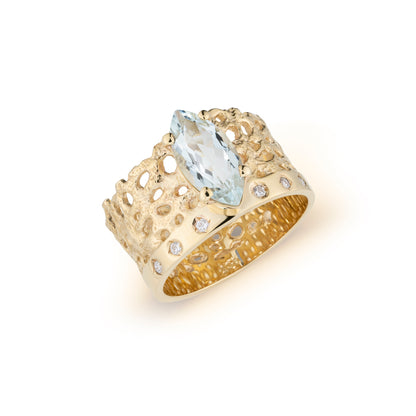 Gold ring with a large blue gemstone on a white background